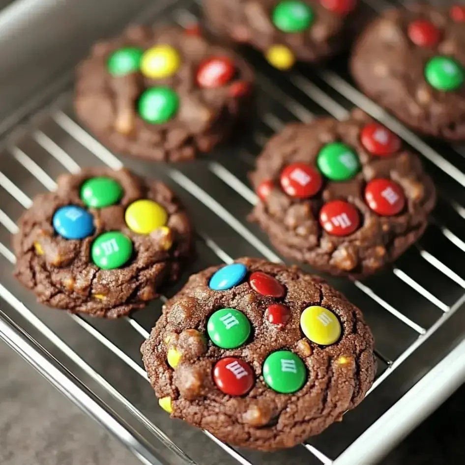 A tray of freshly baked chocolate cookies topped with colorful candy-coated chocolates.