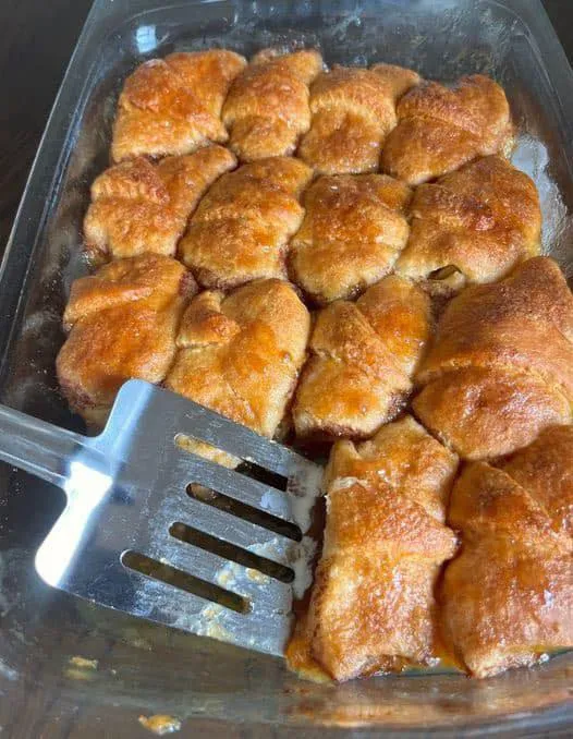 A fork is stuck in a pan of food.