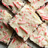 A close-up of chocolate peppermint bark, featuring white chocolate topped with crushed peppermint candies and red striped candy pieces.