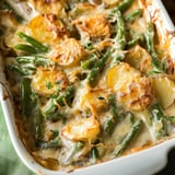 A creamy, baked dish featuring golden potatoes and green beans topped with a crispy layer.